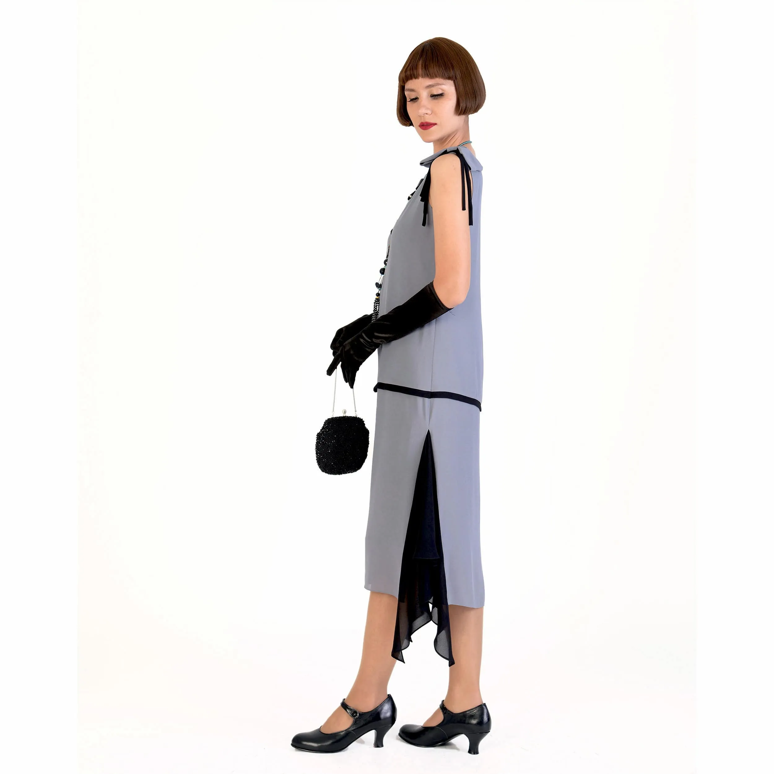 Grey party dress in 1920s style with black details and shoulder bow